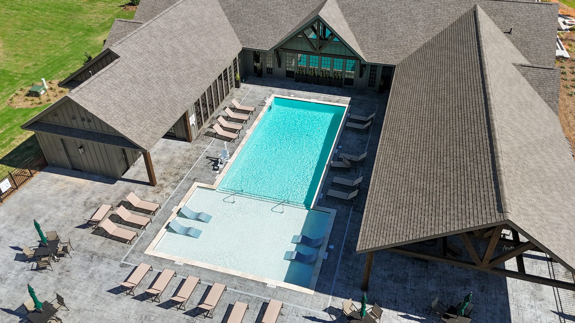 Cabana loungers and the pool pavilion seen from above — resort-level living.