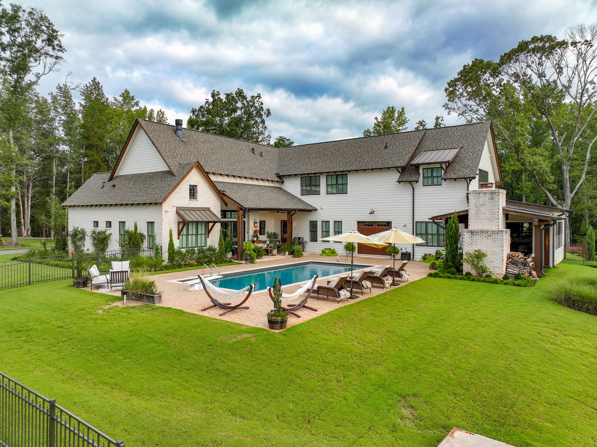 Hammock, pavilion, and rolling lawn stretch behind the Newton residence.