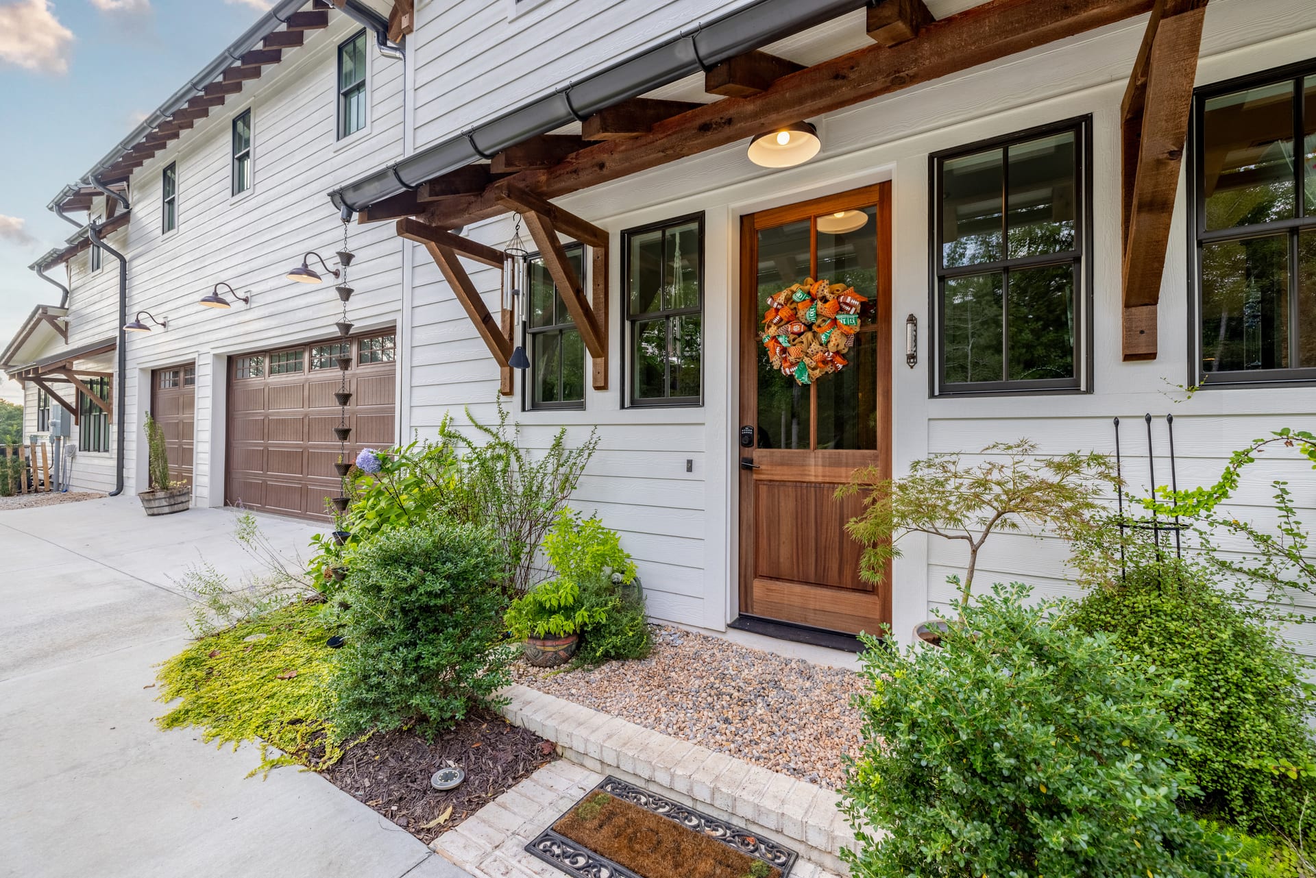Wood garage door and timber brackets add craft to the entry facade.