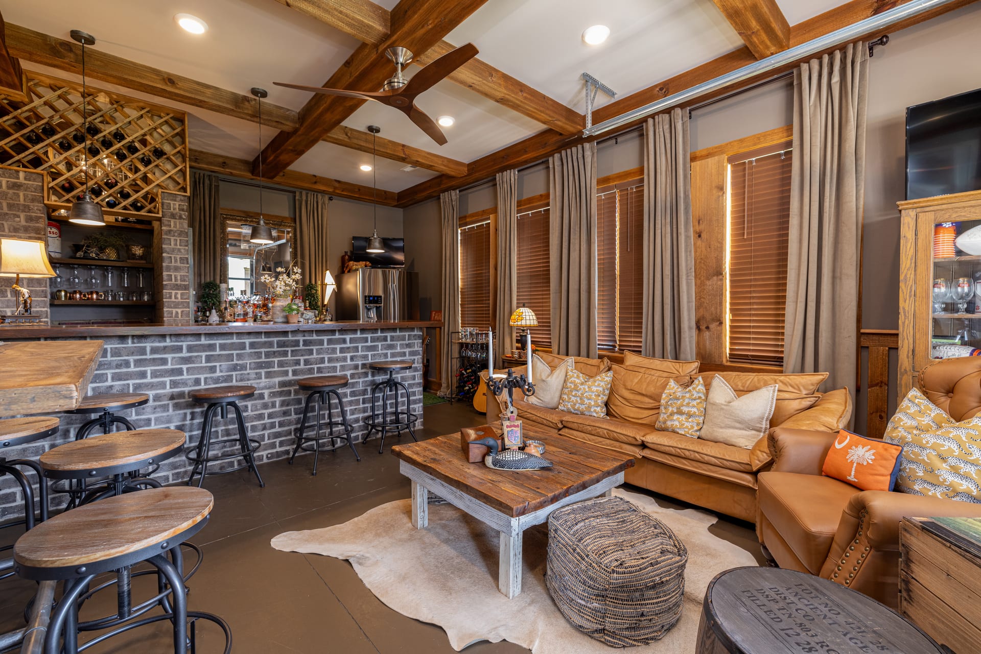 Leather, brick, and reclaimed beams converge in the Newton bonus room.