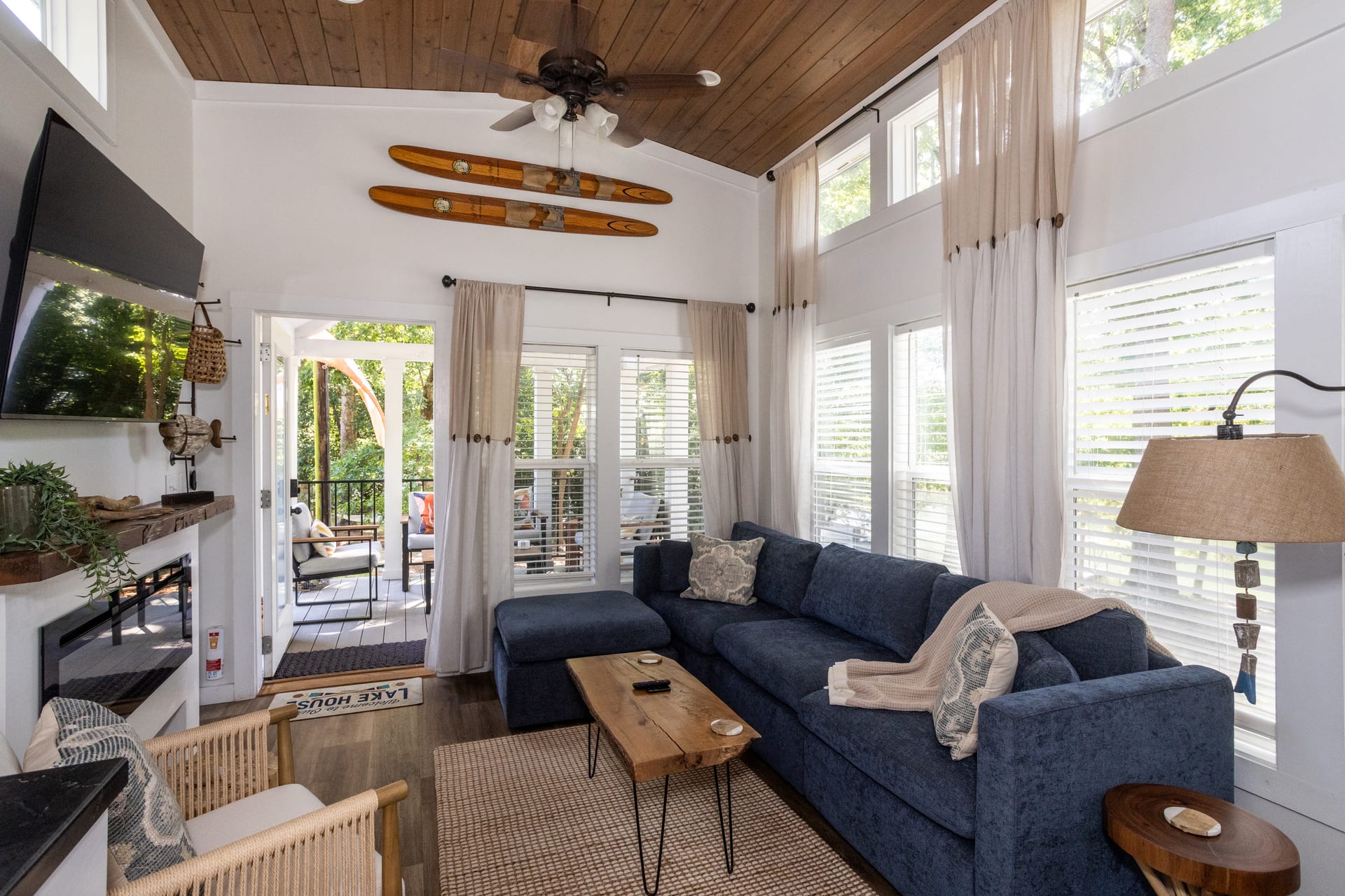 Wood plank ceiling and navy upholstery anchor the Shiloh living room.