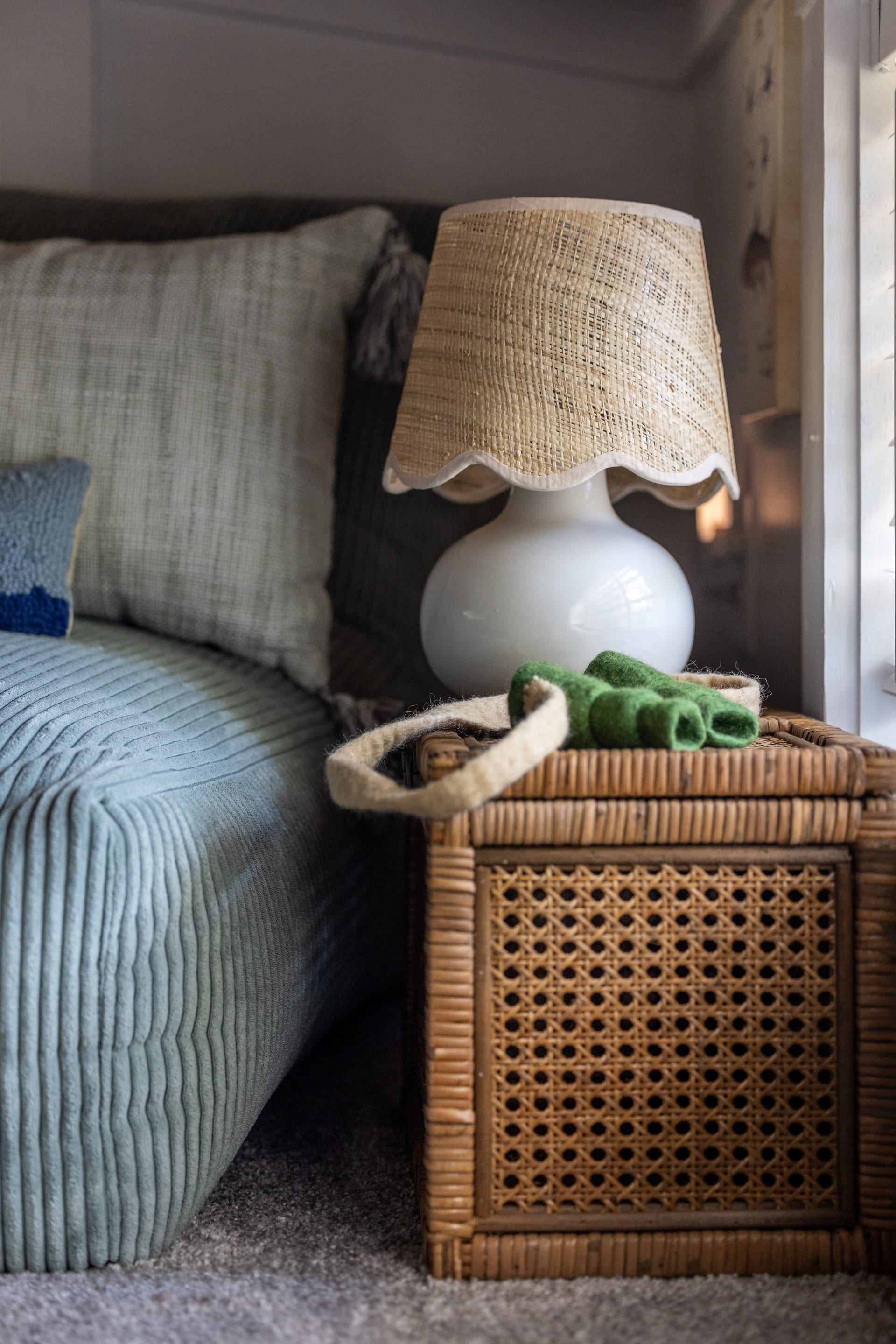 Sage corduroy sofa paired with rattan and burlap for textured lakeside living.