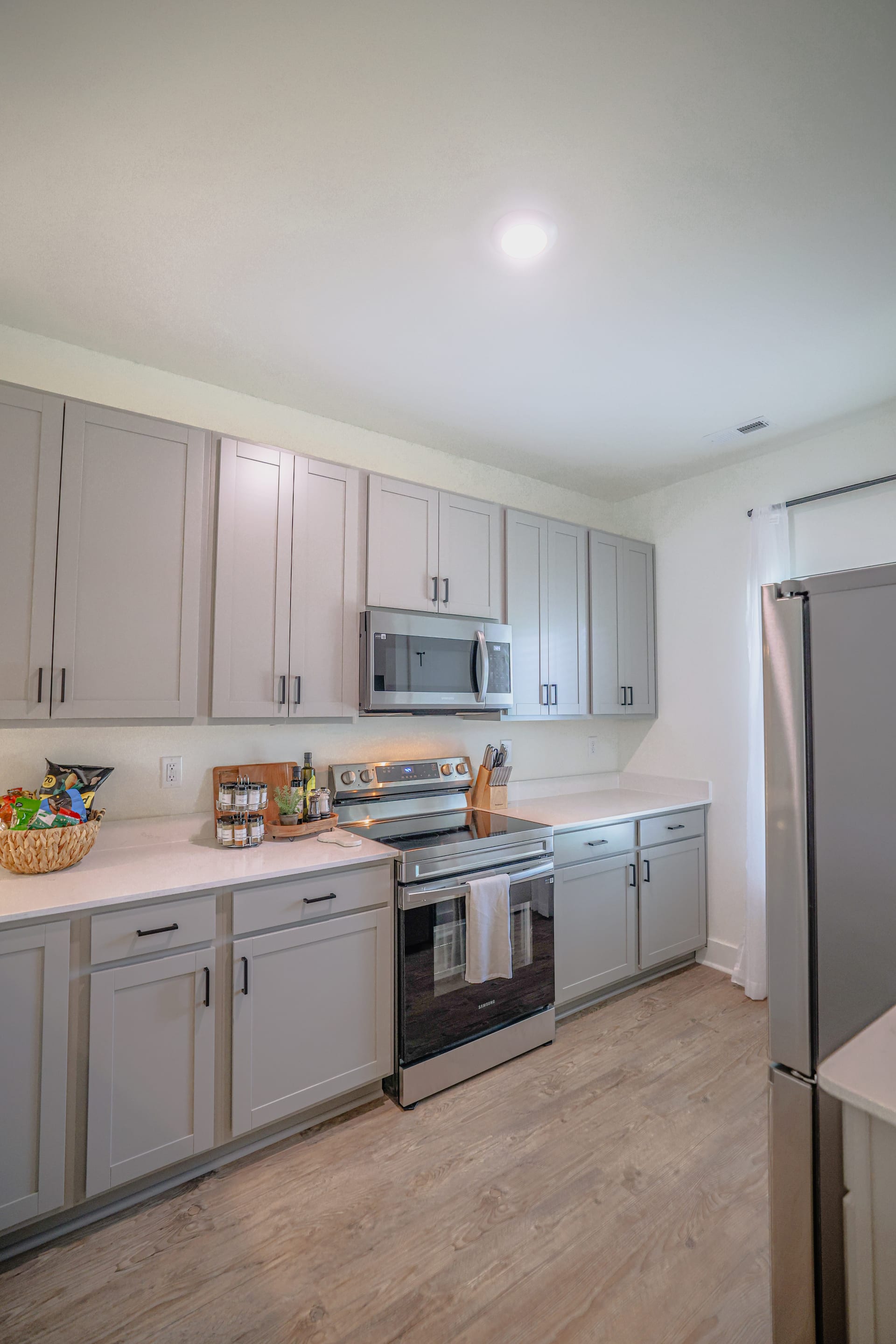 Grey cabinetry and stainless steel create a clean, timeless kitchen.