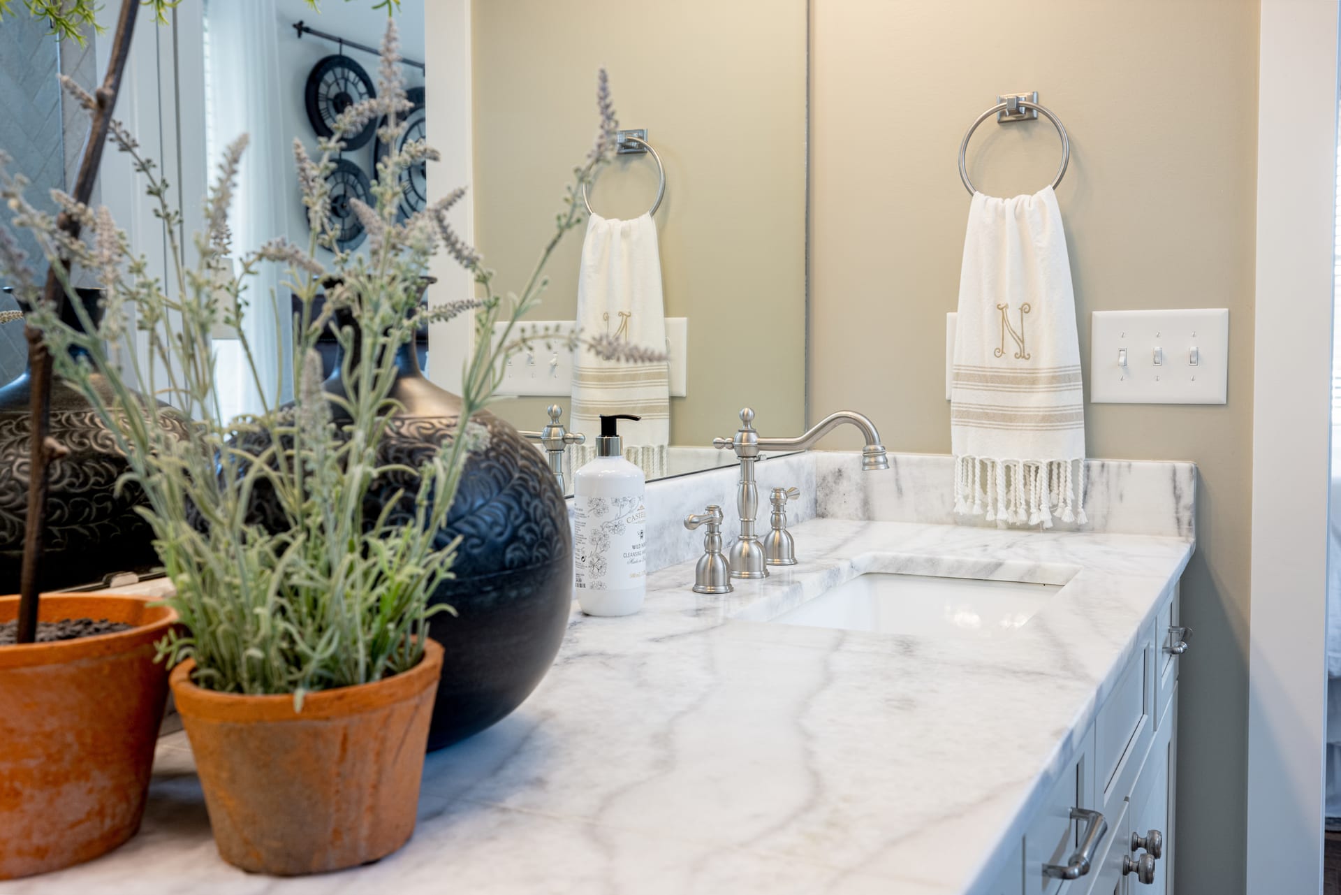 Marble vanity and a sprig of lavender — quiet luxury in every detail.