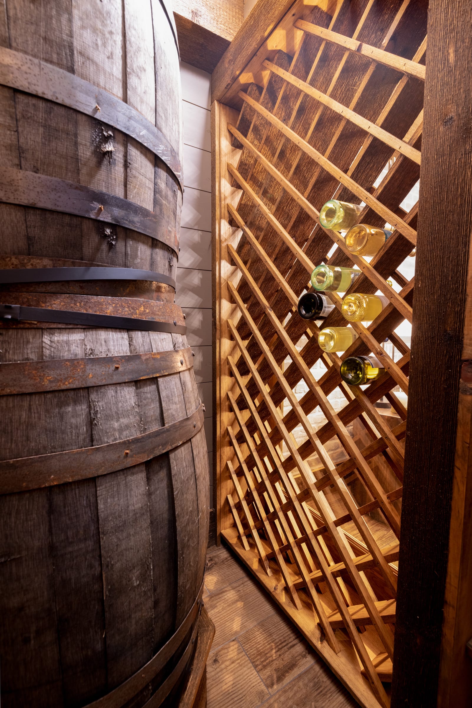 Diamond wine rack and oak barrel — a cellar built for slow evenings.