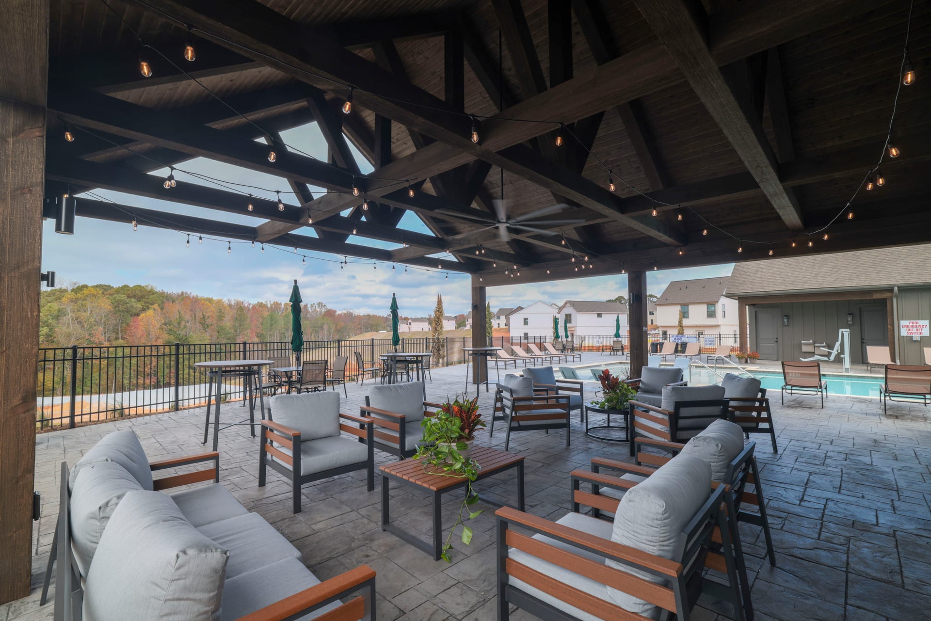 String lights drape the cabana pavilion for effortless poolside evenings.