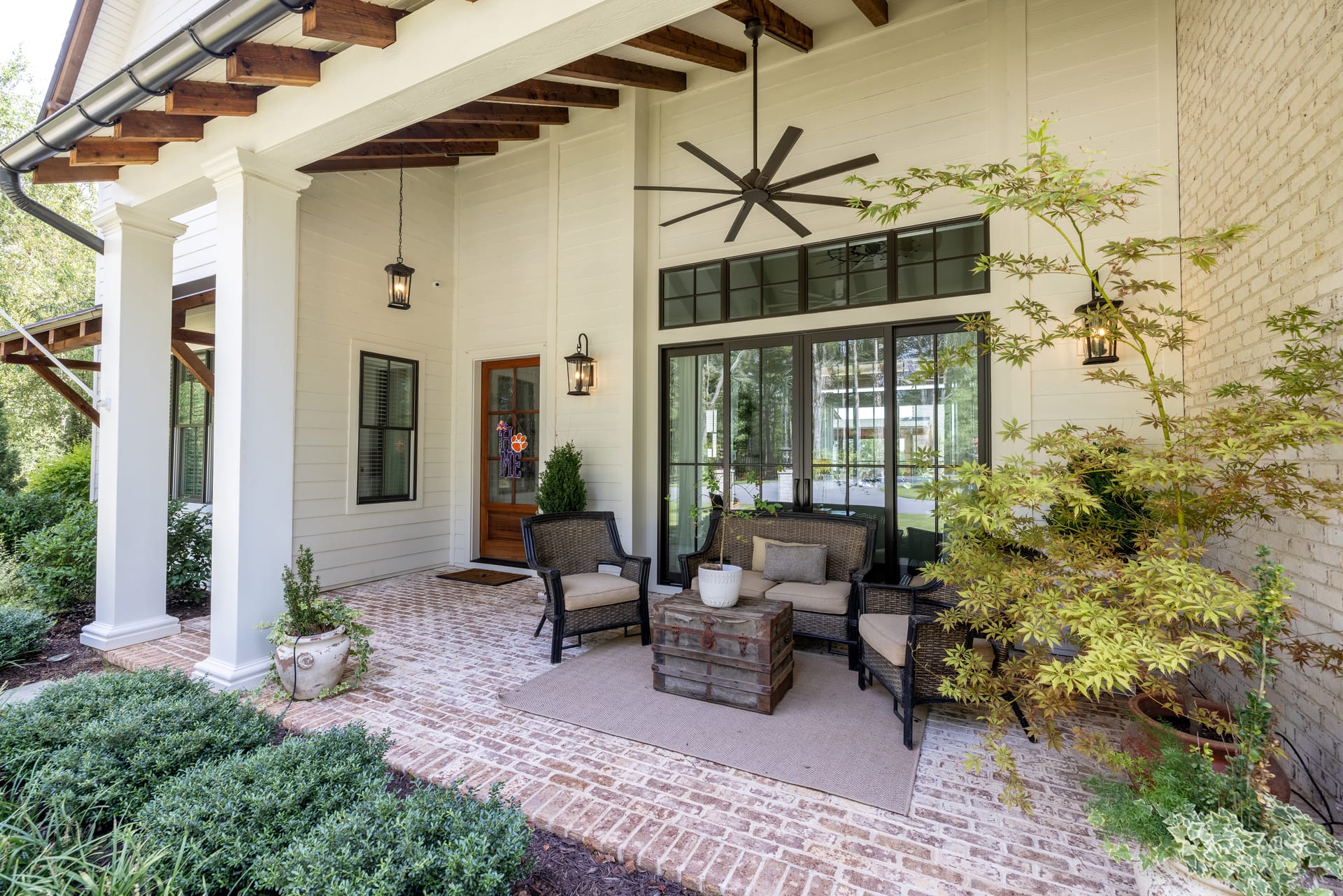Wicker chairs on the covered porch invite slow mornings and long conversations.