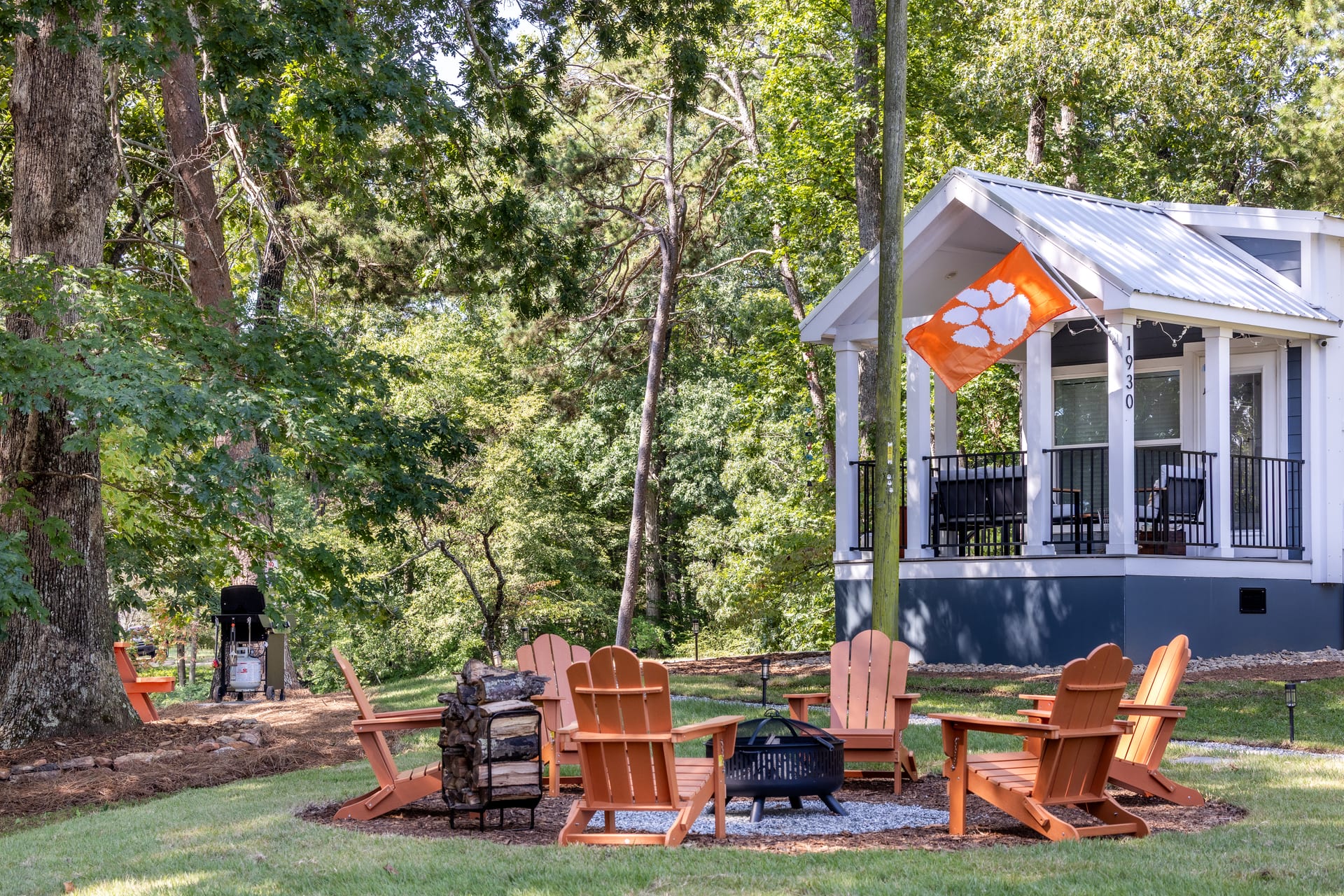Fire pit glow and covered porch frame the Shiloh cottage at dusk.